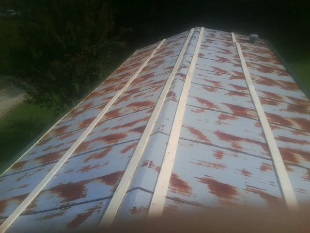 Rusted metal roof panels with new wood purlins before replacement — Storm Damage Roof Repair in Fingerville by Roofing Brothers